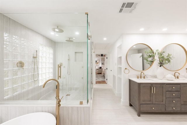 bathroom featuring vanity and tiled shower