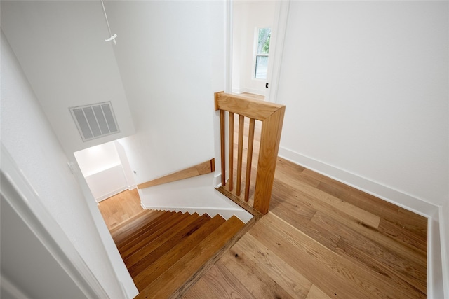 staircase featuring wood-type flooring