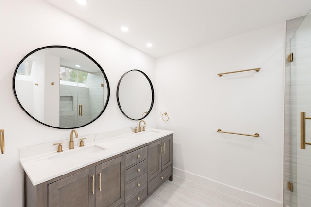 bathroom with vanity and a shower with shower door