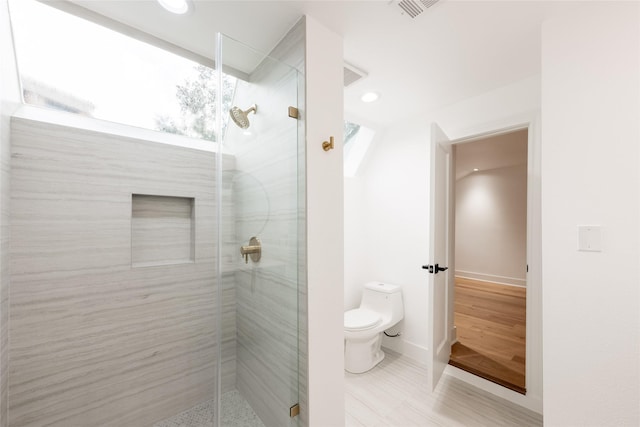 bathroom with toilet and walk in shower