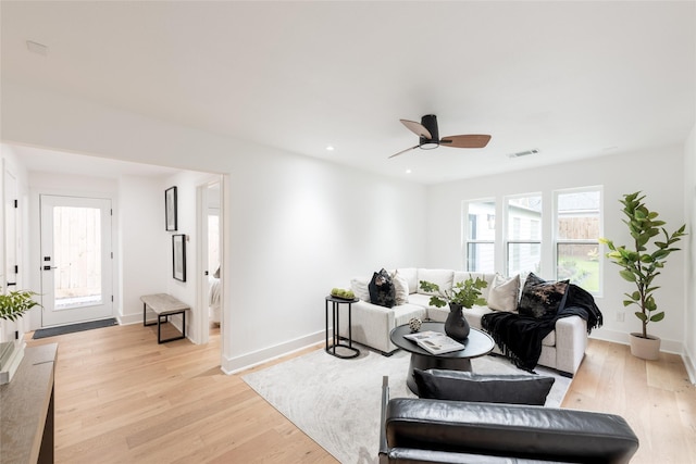 living room featuring ceiling fan and light hardwood / wood-style flooring