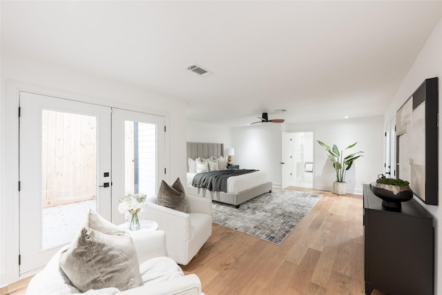 bedroom with ceiling fan, access to exterior, french doors, and light hardwood / wood-style flooring