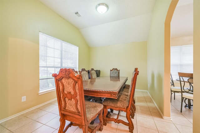 tiled dining area featuring lofted ceiling