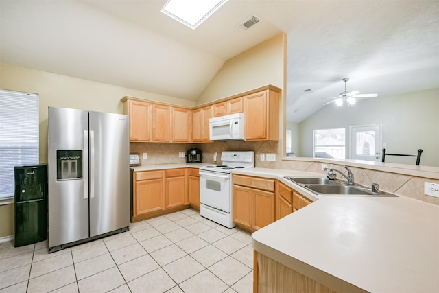 kitchen with white appliances, vaulted ceiling, ceiling fan, sink, and light tile patterned flooring