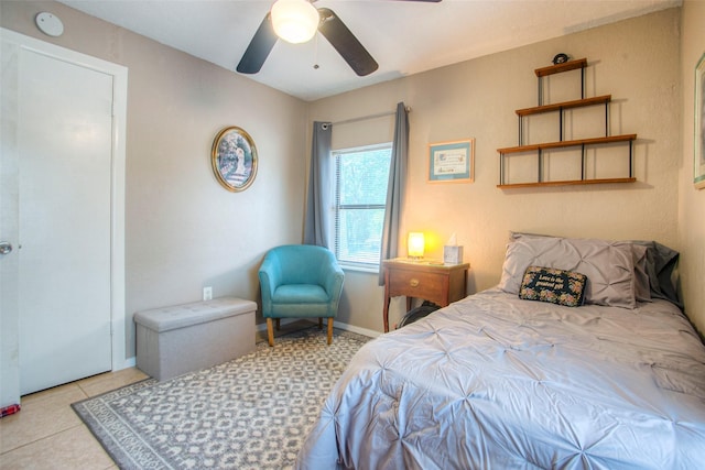 bedroom with ceiling fan and light tile patterned flooring