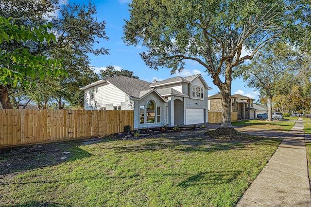 view of front of house featuring a garage and a front yard