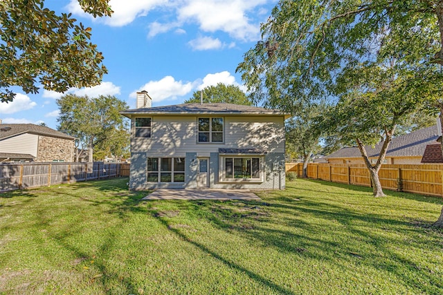 back of property with a yard and a patio