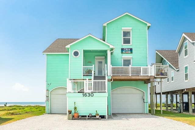 view of front facade with a water view and a garage