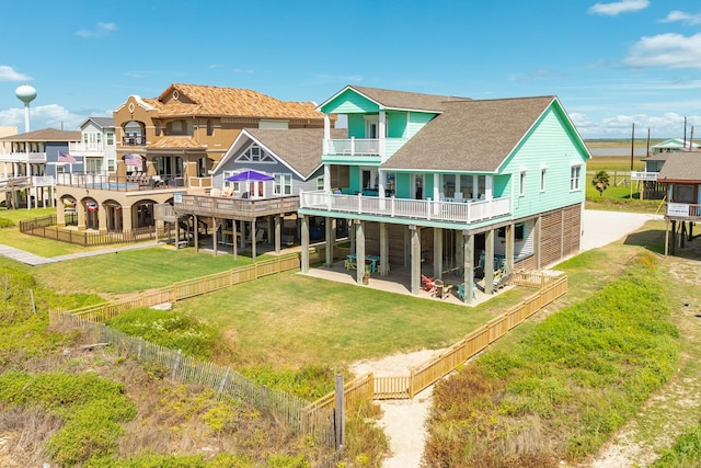 back of house featuring a lawn and a patio area