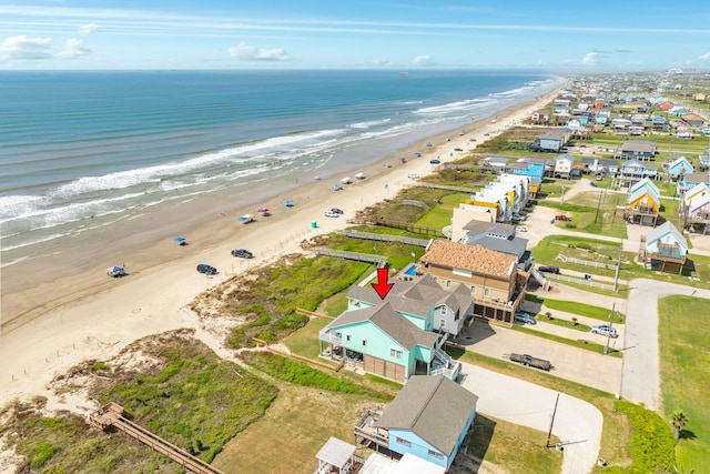 birds eye view of property with a water view and a view of the beach