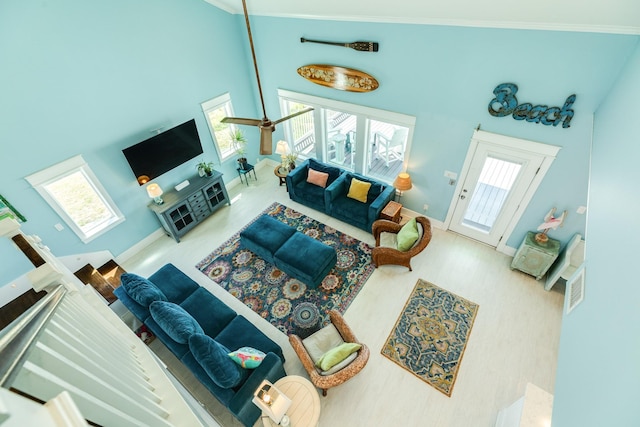 living room with high vaulted ceiling and a healthy amount of sunlight