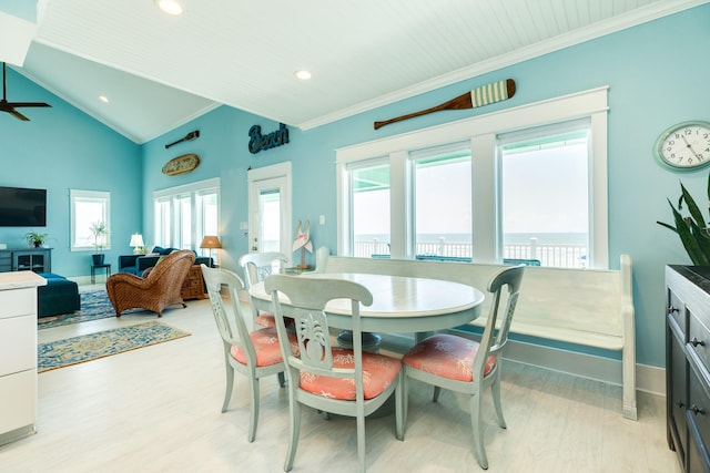 dining space featuring light hardwood / wood-style floors, lofted ceiling, and crown molding