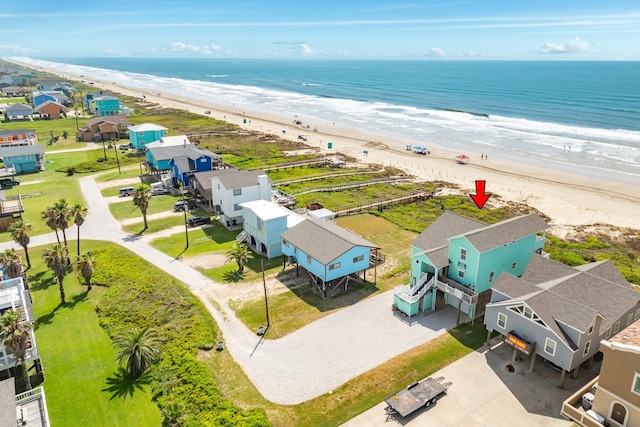 drone / aerial view featuring a water view and a beach view