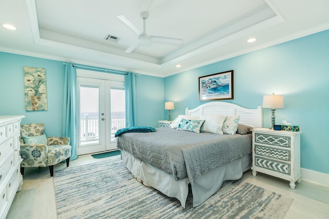 bedroom with a raised ceiling, access to exterior, and ceiling fan