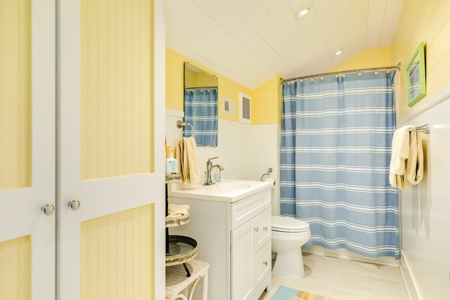 bathroom with a shower with shower curtain, vanity, toilet, and lofted ceiling