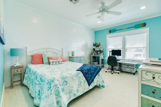 bedroom featuring ceiling fan, light hardwood / wood-style flooring, and crown molding