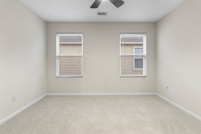 unfurnished room with carpet and ceiling fan