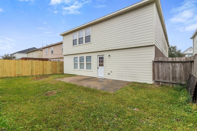 back of property featuring a yard and a patio