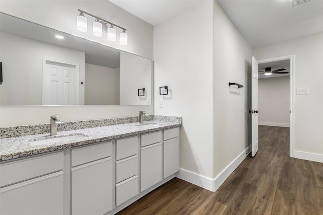 bathroom with ceiling fan, vanity, and wood-type flooring