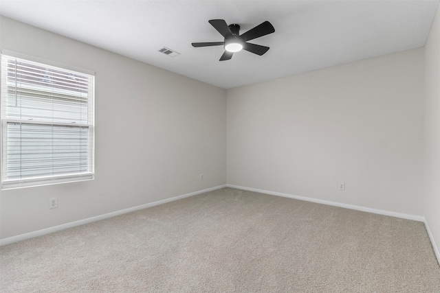 carpeted spare room featuring ceiling fan