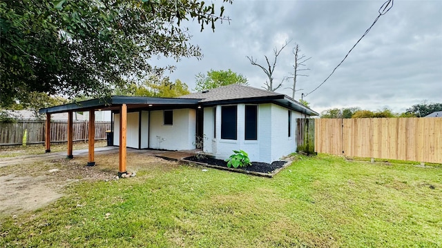 rear view of property featuring a yard