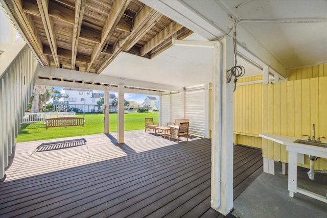 wooden terrace featuring a lawn