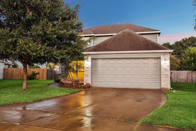 view of front of home featuring a garage and a yard