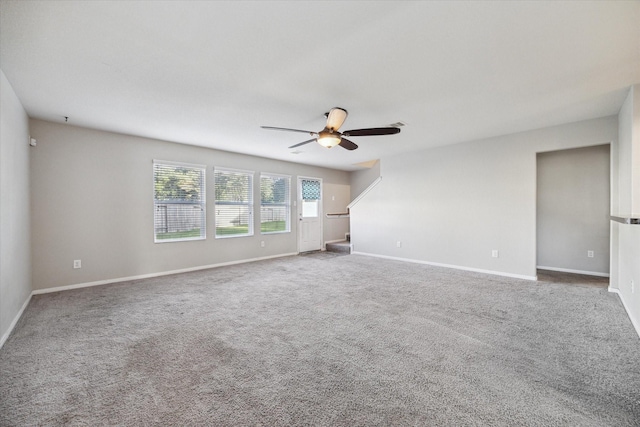 unfurnished room featuring ceiling fan and carpet floors