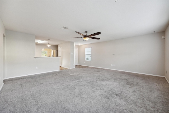 unfurnished living room with ceiling fan and carpet floors