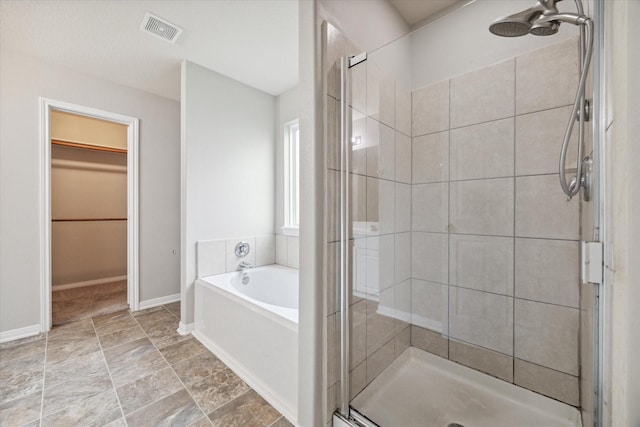 bathroom featuring ceiling fan and plus walk in shower