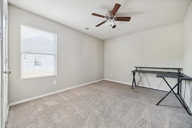 empty room with carpet, a wealth of natural light, and ceiling fan