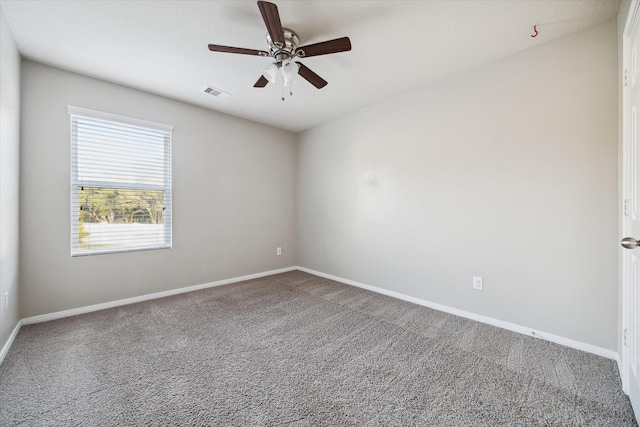 carpeted spare room with ceiling fan