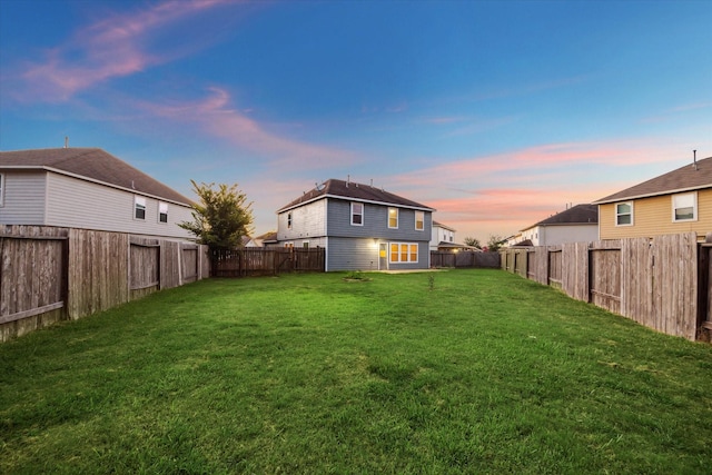 view of yard at dusk