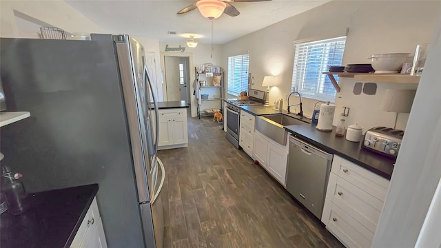 kitchen featuring dark hardwood / wood-style flooring, stainless steel appliances, ceiling fan, sink, and white cabinets