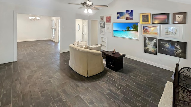 living room featuring lofted ceiling, ceiling fan with notable chandelier, and dark hardwood / wood-style floors