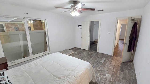 bedroom with ceiling fan and dark hardwood / wood-style flooring