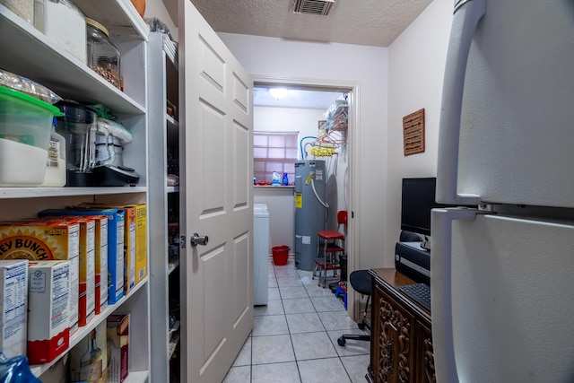 pantry with electric water heater and washer / clothes dryer