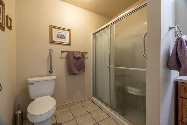 bathroom featuring vanity, tile patterned flooring, toilet, a textured ceiling, and an enclosed shower