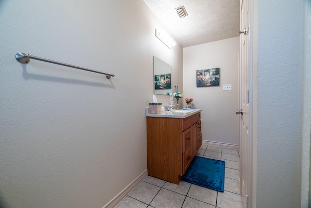 bathroom featuring vanity, a textured ceiling, and tile patterned floors