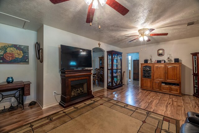 living room with hardwood / wood-style flooring and a textured ceiling