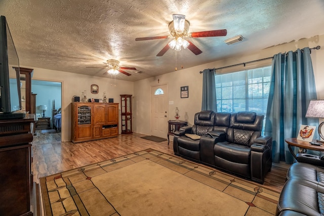 living room featuring hardwood / wood-style floors and a textured ceiling