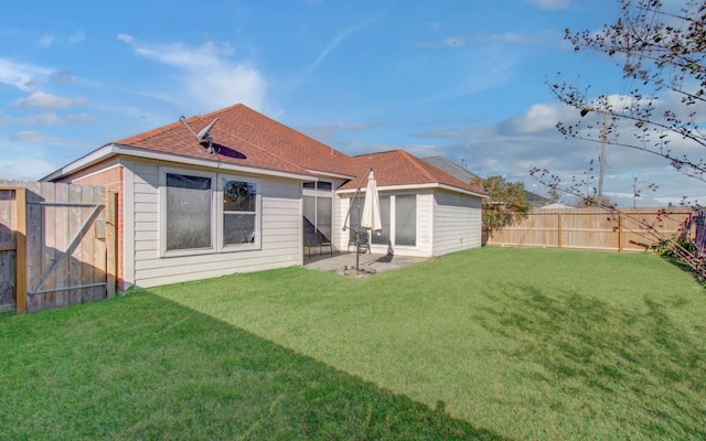 back of property with a patio area and a lawn