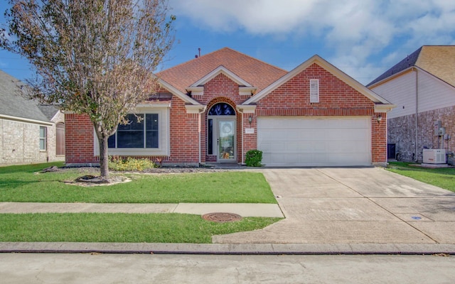 view of front of house with a garage and a front lawn