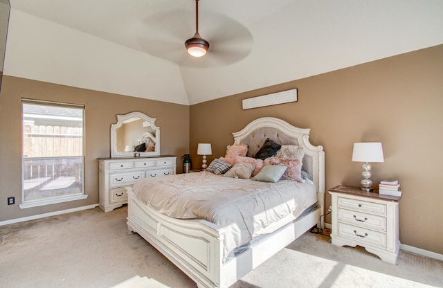 bedroom with ceiling fan, light colored carpet, and vaulted ceiling