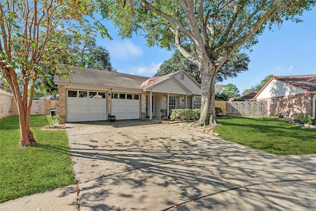 ranch-style house featuring a front yard and a garage