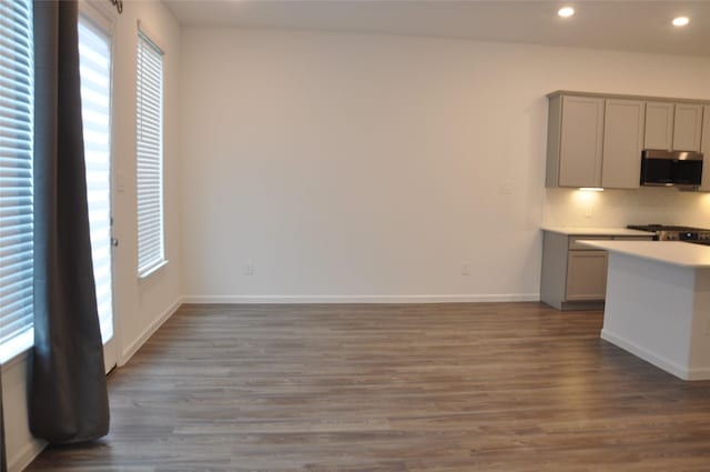 kitchen featuring appliances with stainless steel finishes, gray cabinets, and dark wood-type flooring