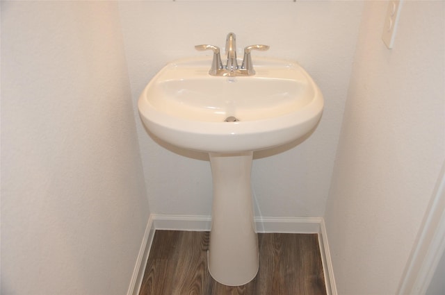 bathroom featuring wood-type flooring and sink