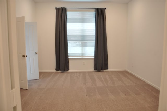 unfurnished room with light colored carpet