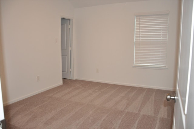 empty room featuring light carpet