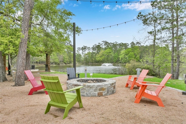 view of patio / terrace featuring a water view and an outdoor fire pit